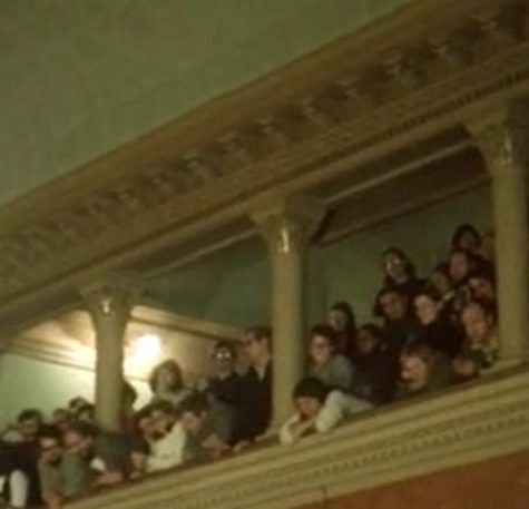 A packed peanut gallery in the Cambridge rent control hearing room shows people shoulder to shoulder watching and listening to what happened below.